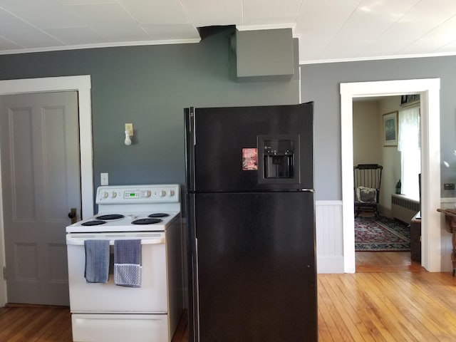 kitchen featuring black fridge, ornamental molding, wood-type flooring, white electric range, and radiator heating unit