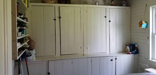 mudroom featuring wood walls