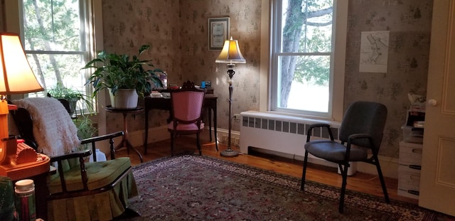 sitting room featuring wood-type flooring and radiator