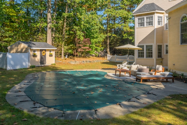 view of pool with a yard, an outdoor structure, a patio area, and an outdoor hangout area