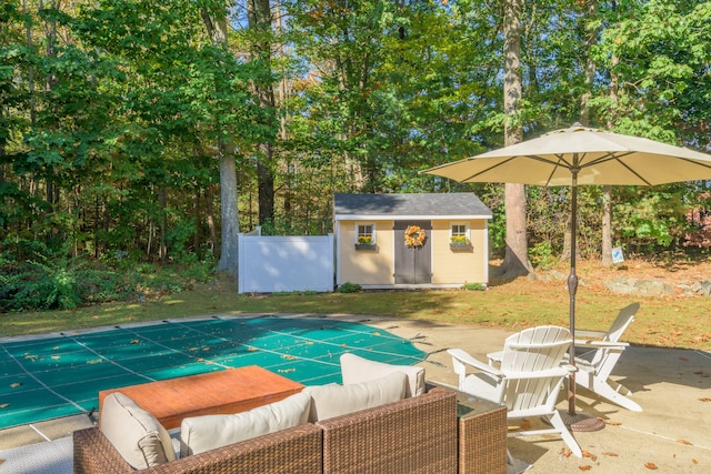 view of pool featuring a patio and an outbuilding