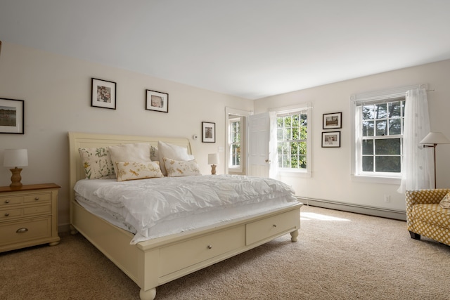 carpeted bedroom featuring baseboard heating