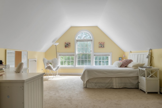 bedroom featuring lofted ceiling and light colored carpet