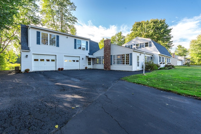 view of front of house with a garage and a front yard