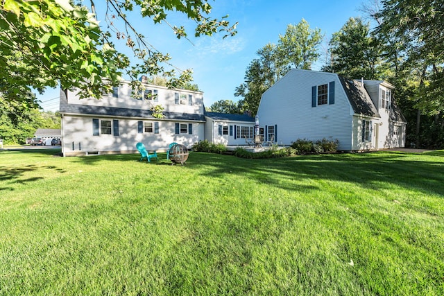 rear view of house with a yard