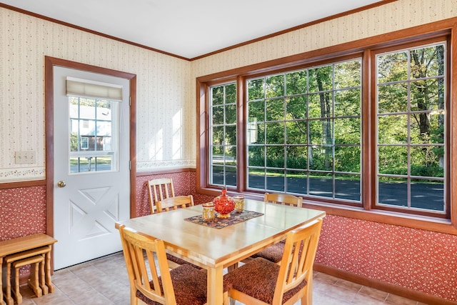 dining area featuring light tile patterned floors and ornamental molding