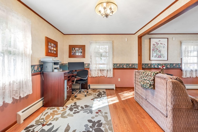 office with a baseboard heating unit, plenty of natural light, and light wood-type flooring