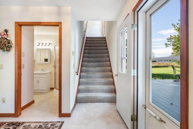 staircase with sink and a healthy amount of sunlight