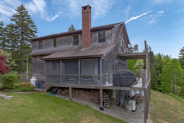 back of property featuring a sunroom and a yard