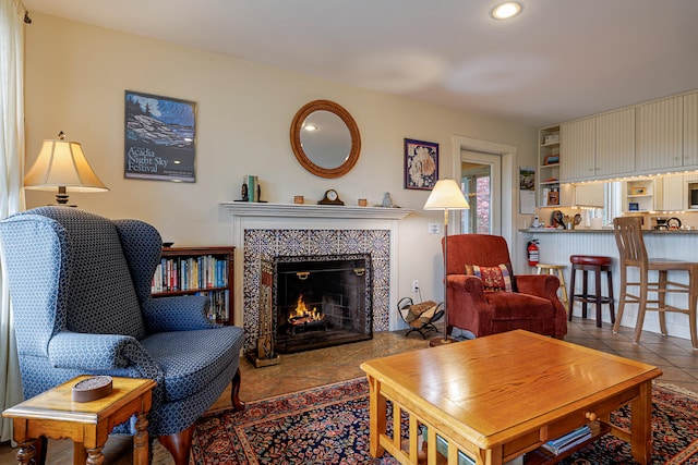 tiled living room with a tile fireplace