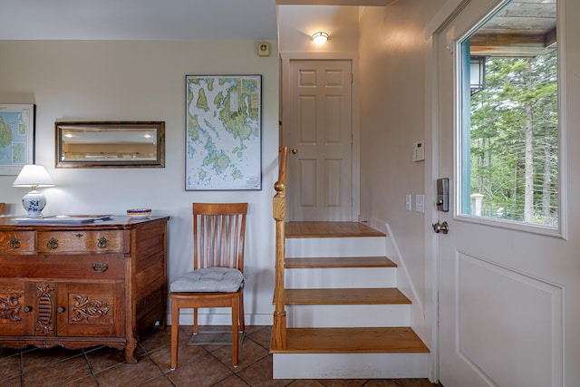 staircase featuring tile patterned flooring and a wealth of natural light