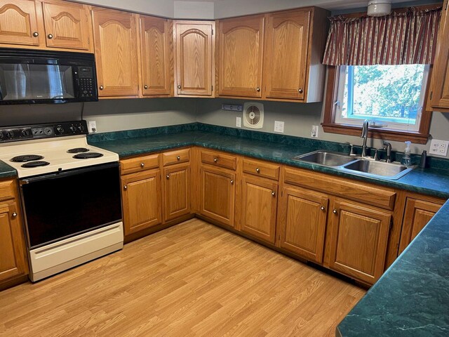 kitchen featuring white range with electric cooktop, sink, and light hardwood / wood-style flooring