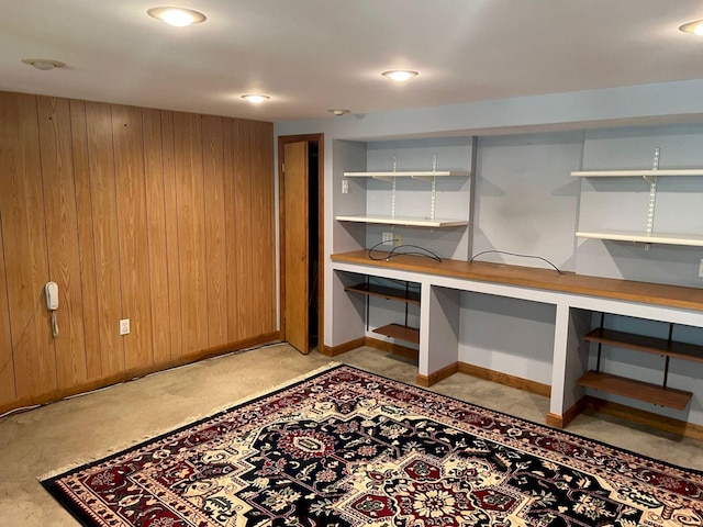 basement featuring wood walls