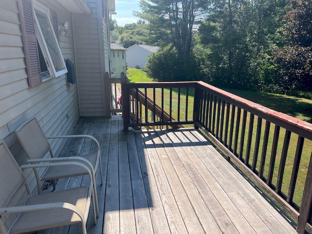 wooden terrace with a lawn