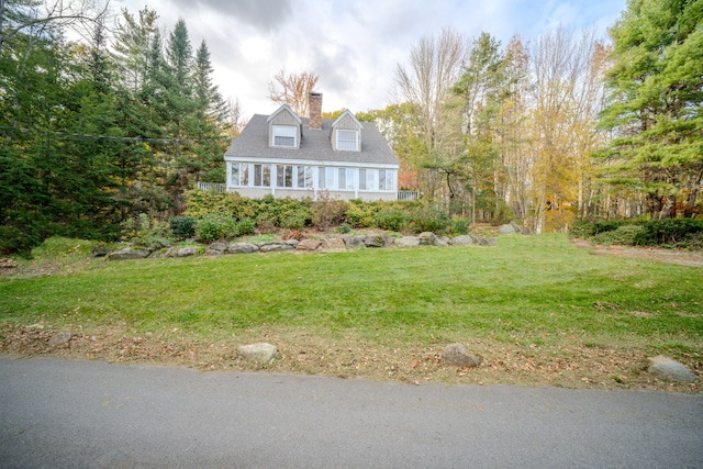 cape cod home with a front yard