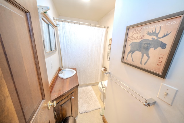 bathroom featuring vanity, a shower with shower curtain, and toilet