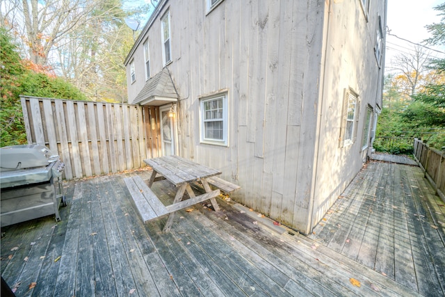 wooden terrace with a grill