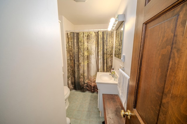 bathroom featuring vanity, tile patterned floors, toilet, and walk in shower