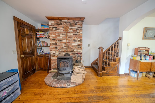 living room featuring light hardwood / wood-style flooring and a wood stove