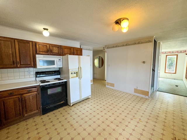 kitchen featuring decorative backsplash, white appliances, and a textured ceiling