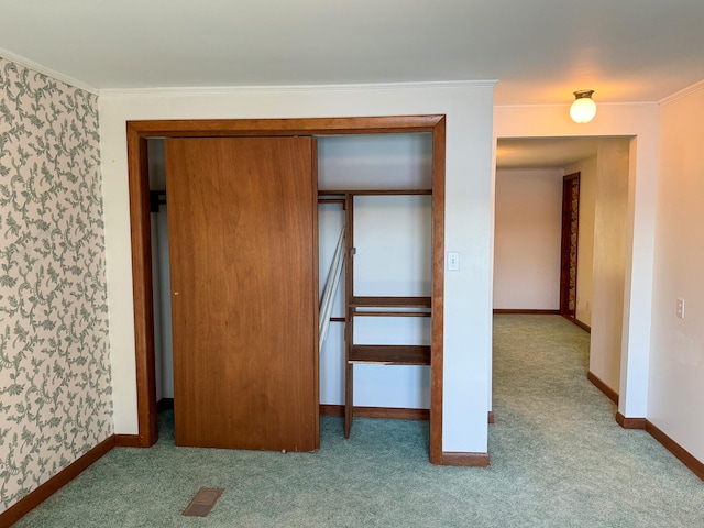 unfurnished bedroom featuring crown molding and light colored carpet