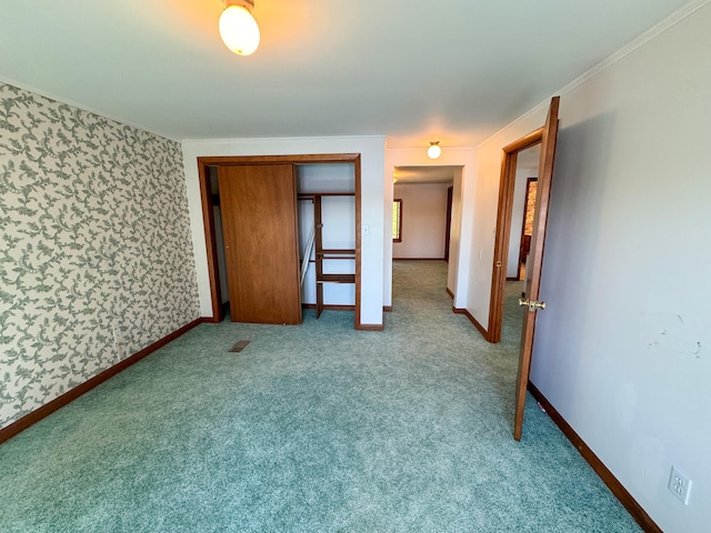 unfurnished bedroom featuring light carpet, a closet, and ornamental molding