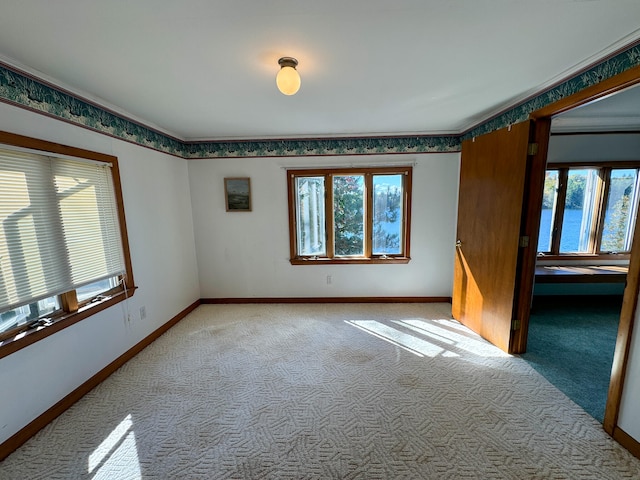 spare room with a healthy amount of sunlight and light colored carpet