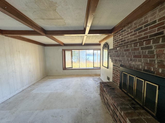 unfurnished living room with coffered ceiling, beamed ceiling, a brick fireplace, and a textured ceiling