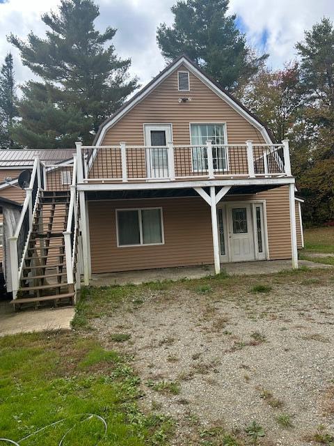 473 Wolfboro Rd, Stetson, ME 04488 - back of property with a gambrel roof and stairway