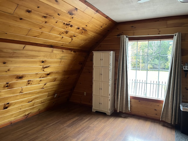 473 Wolfboro Rd, Stetson, ME 04488 - additional living space with lofted ceiling, wooden walls, and wood finished floors