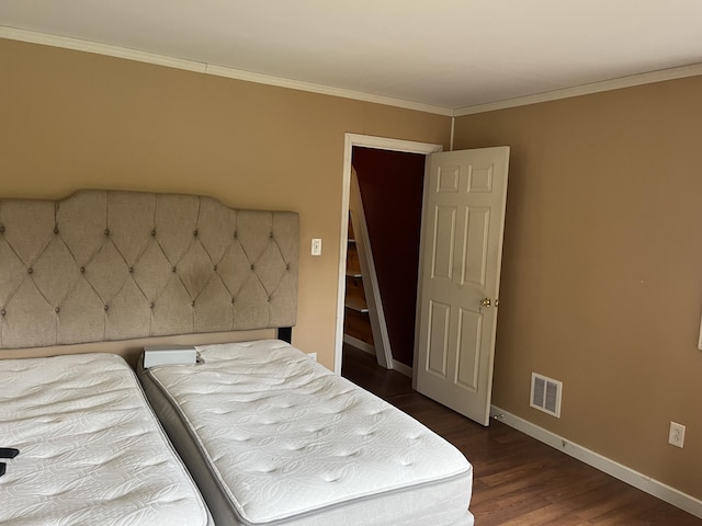473 Wolfboro Rd, Stetson, ME 04488 - bedroom with dark wood-style flooring, visible vents, crown molding, and baseboards