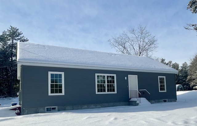 view of snow covered rear of property