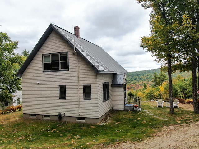 view of side of property featuring a yard and a mountain view