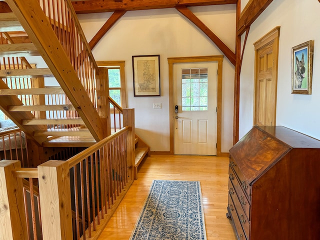 foyer with beamed ceiling, light hardwood / wood-style flooring, and plenty of natural light