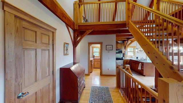 hallway with light wood-type flooring and sink