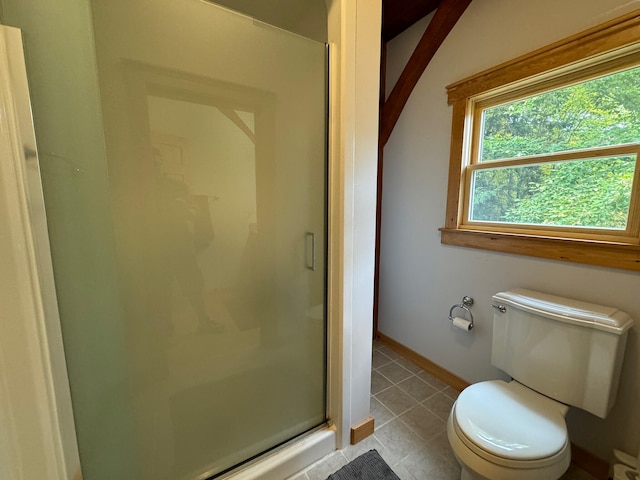 bathroom with walk in shower, tile patterned flooring, and toilet