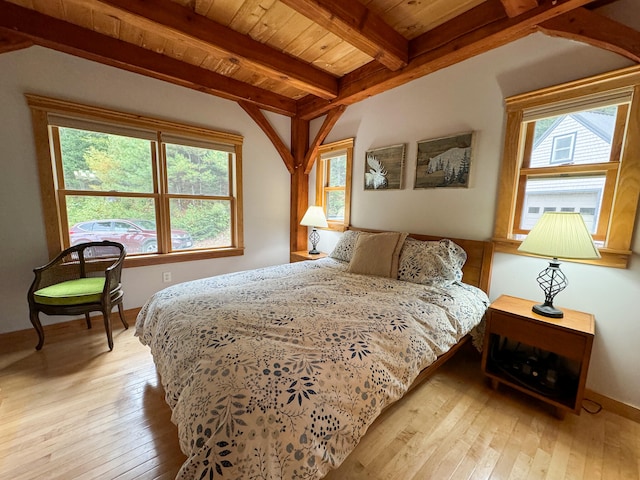 bedroom featuring wood ceiling, beam ceiling, light hardwood / wood-style floors, and multiple windows