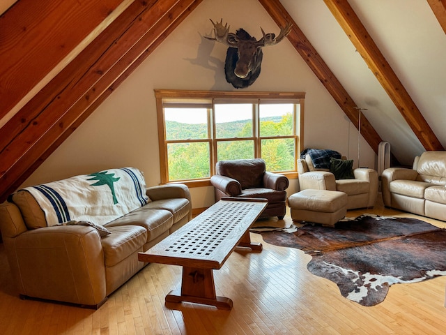 living room featuring light hardwood / wood-style floors and lofted ceiling with beams