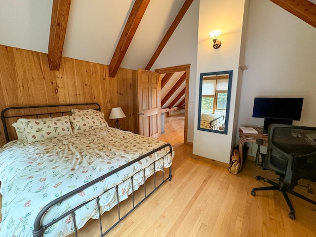 bedroom featuring light wood-type flooring, wood walls, beam ceiling, and high vaulted ceiling