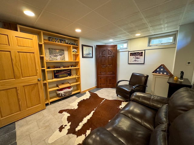 living room with a drop ceiling