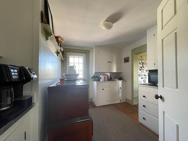 kitchen featuring white cabinetry and hardwood / wood-style floors