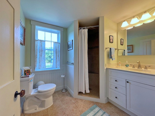 bathroom with toilet, vanity, a shower with shower curtain, and tile patterned flooring