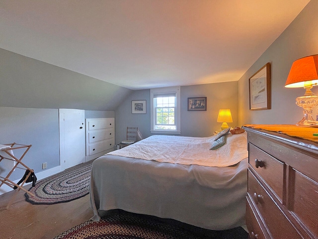 bedroom featuring carpet and vaulted ceiling