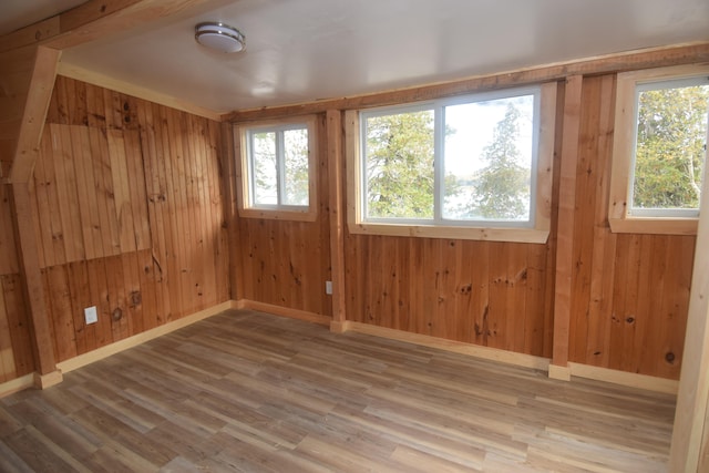 spare room with wood walls and hardwood / wood-style floors