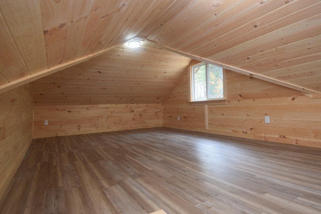 bonus room featuring wooden ceiling, hardwood / wood-style floors, wooden walls, and vaulted ceiling