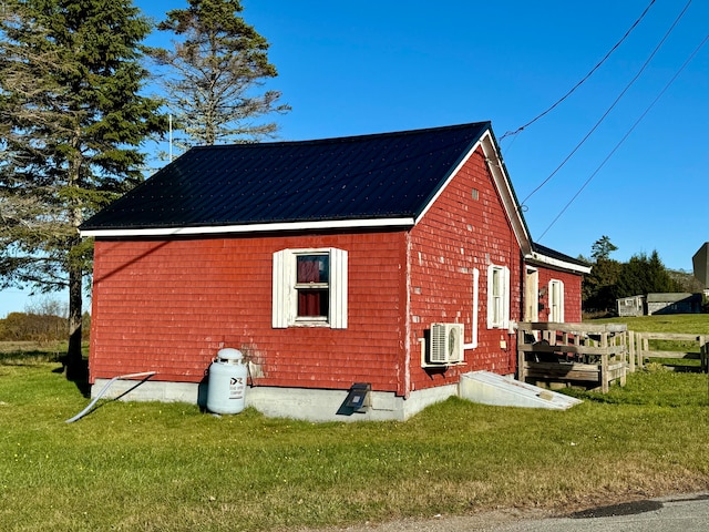 view of home's exterior with a yard and ac unit