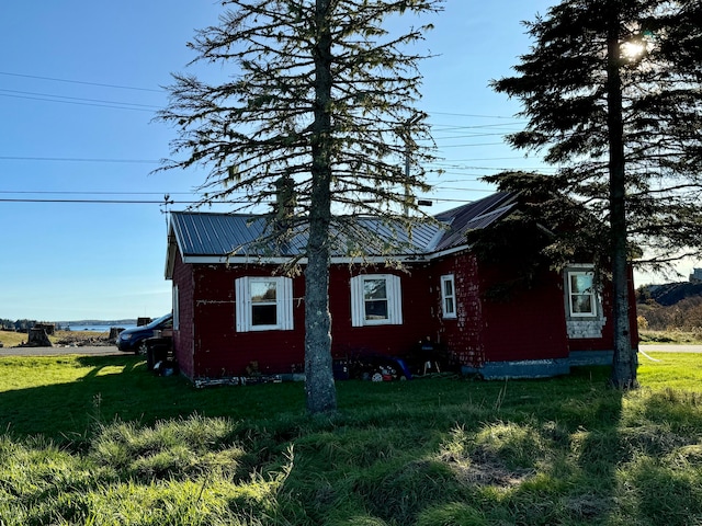 view of side of home with a lawn