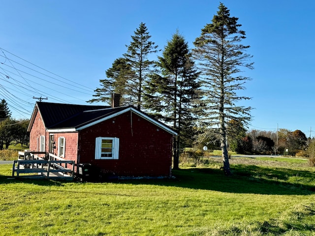 view of side of home with a lawn