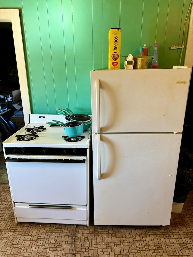 kitchen featuring green cabinets and white appliances