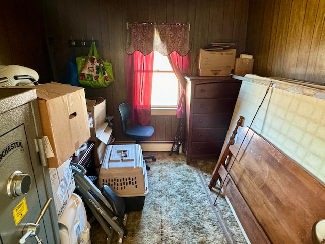 bedroom with carpet floors and wooden walls